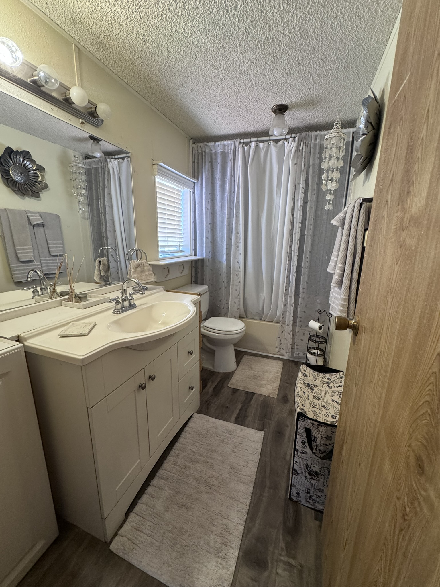 The guest bathroom — tub and shower with updated flooring