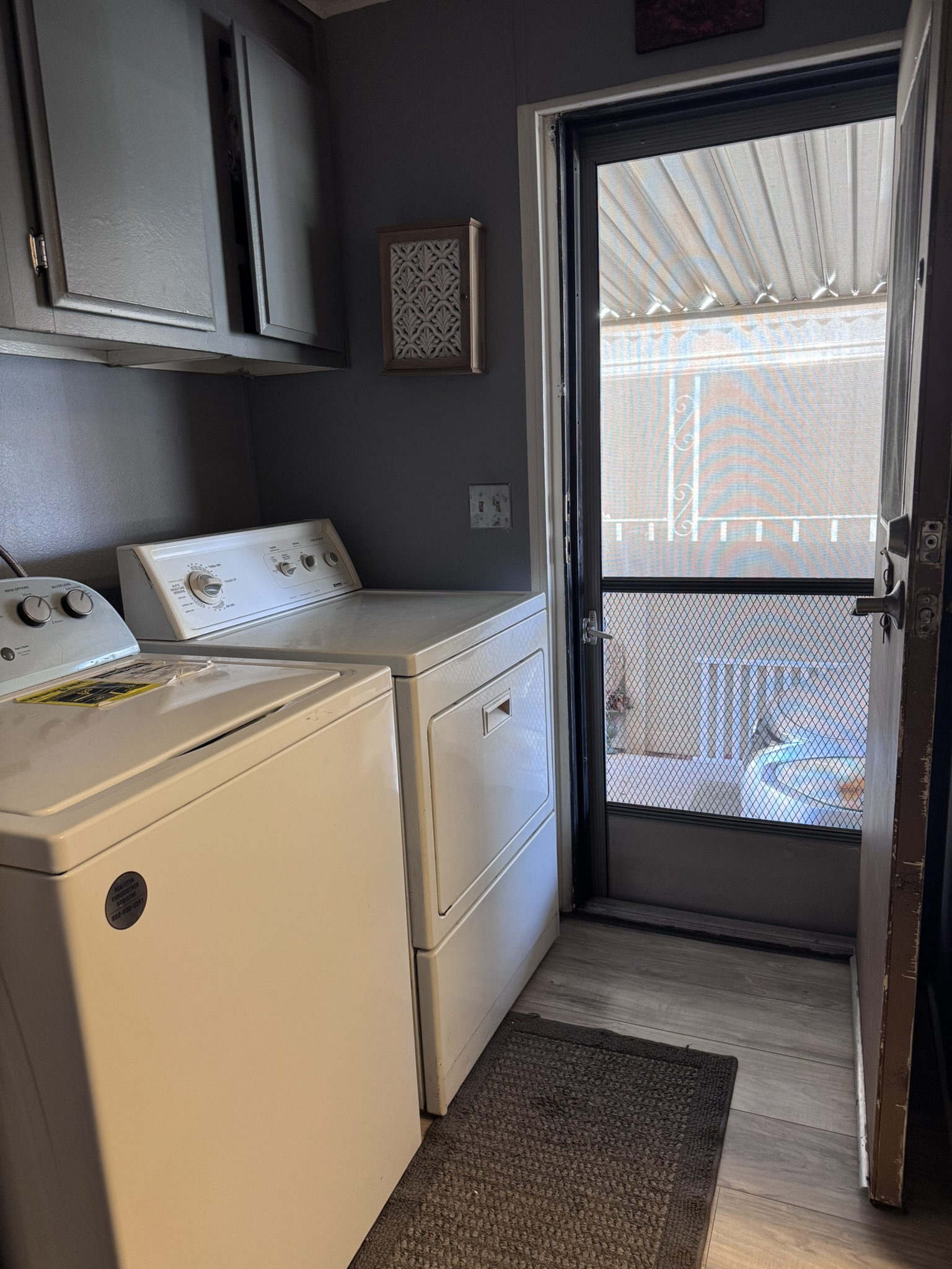 The laundry room — full-size washer and dryer with direct outdoor access