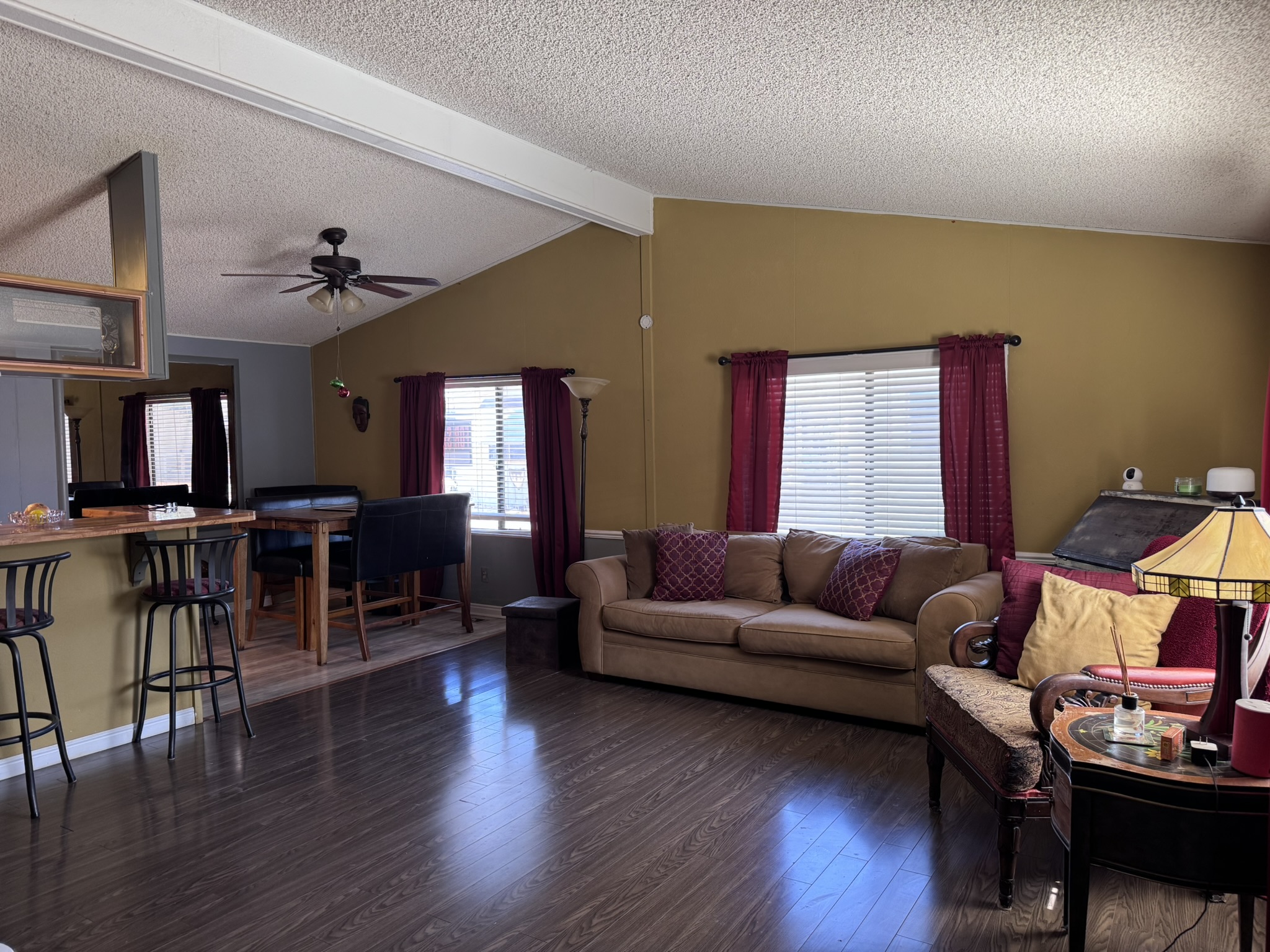 The living room — warm wood floors and generous natural light