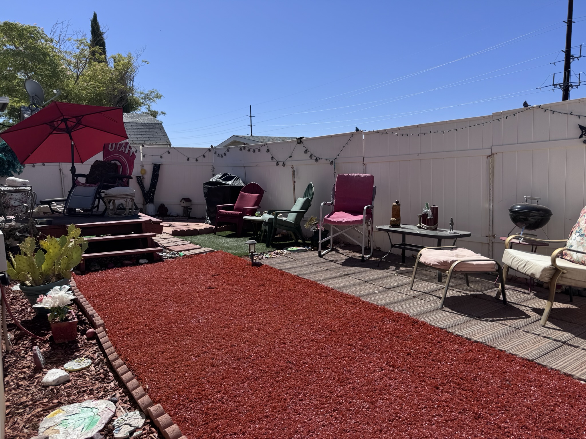 The private backyard patio — fenced, shaded, and ready for gatherings